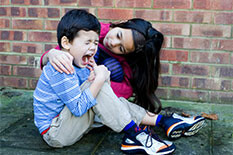 Picture of a woman caring for a upset child